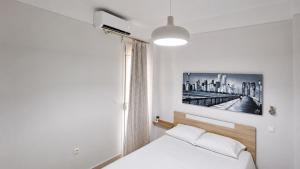 a bedroom with a bed with a picture on the wall at Angels' House in Thessaloniki
