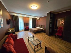 a living room with a couch and a bed at Hotel Nika in Chornomorsk +41 photos