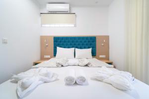 a bedroom with a bed with white towels on it at Hotel Medusa in Skala Prinou