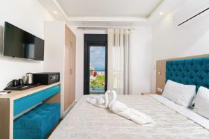 a hotel room with a bed with a blue headboard at Hotel Medusa in Skala Prinou