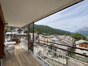 a balcony with a view of a city at Central Spacious Apartment, Mountain Views in Sauze d'Oulx