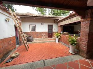 a brick patio with a ladder in front of a house at Kinmen Jinyuge Heritage B&B- Shuitou Minnan Village in Hsia-shih