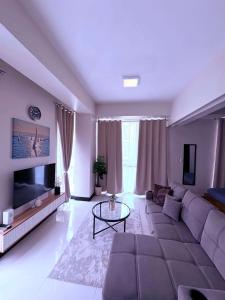 a large living room with a couch and a tv at 8 Newtown boulevard in Punta Engaño