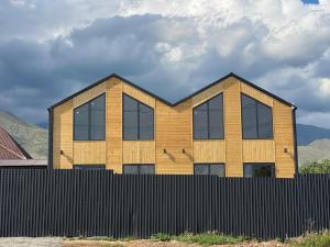 a house with a fence in front of it at Банрхаус in Cholpon-Ata