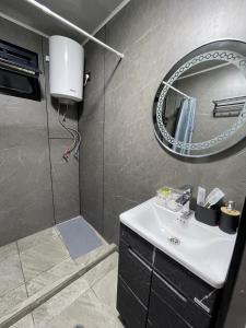 a bathroom with a sink and a mirror at Банрхаус in Cholpon-Ata +9 photos