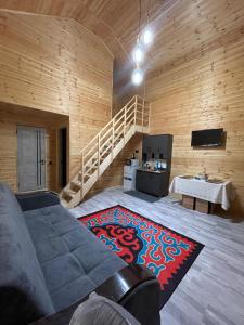 a living room with a couch and a rug at Банрхаус in Cholpon-Ata