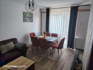 a living room with a dining room table and chairs at Vila Sekvoja in Nova Varoš +21 photos