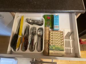 a drawer filled with utensils in a kitchen at Ventlejas in Strakši