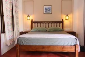 a bedroom with a bed with two pillows at Eden Casa in Mararikulam