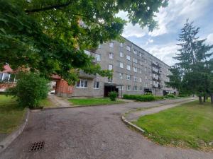 an empty street in front of a large building at Apartment Ventspils iela 22 in Rēzekne