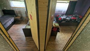 a view of a room with a bed and a mirror at Lali`s Guest House in Juta in Jut'a +2 photos