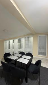a dining room with a table and chairs and a window at Vivko apartmani 2 in Ostrovo