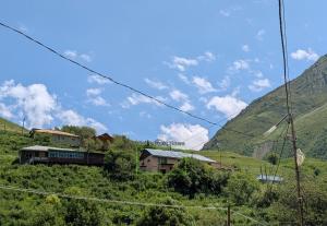 a train on a hill with a house on it at Lali`s Guest House in Juta in Jut'a
