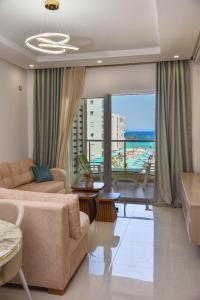 a living room with a couch and a view of the ocean at L'escapade in Sousse