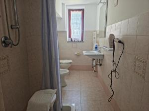 a bathroom with a toilet and a sink at Casa Vacanze Merion in Piticchio +9 photos