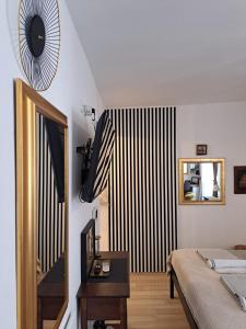 a bedroom with a bed and a mirror on the wall at Apartment Agora in Zadar