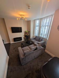 a living room with a couch and a tv at Withnell Stays - Apartment Two - Retro Arcade Machine in Blackpool