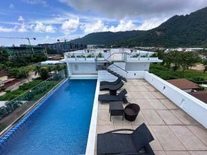 a balcony with a swimming pool on top of a building at Yenna Apt in Kamala Beach