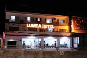 a hotel with a lit up sign in front of it at Khách sạn Lumea in Cam Ranh +11 photos