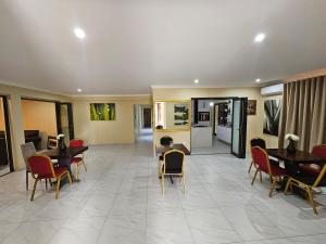 a lobby with tables and chairs in a building at Posimuma Guesthouse Boutique in Centurion