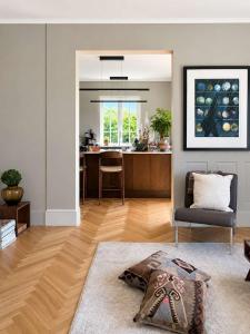 a living room with a chair and a kitchen at SV3G 3BR Villa with Patio in Oslo