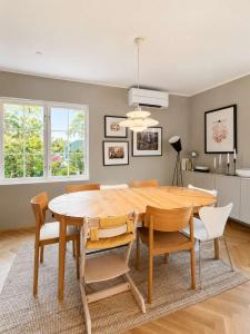 a dining room with a wooden table and chairs at SV3G 3BR Villa with Patio in Oslo