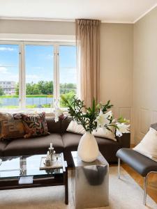 a living room with a couch and a large window at SV3G 3BR Villa with Patio in Oslo