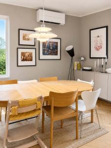 a dining room with a wooden table and chairs at SV3G 3BR Villa with Patio in Oslo