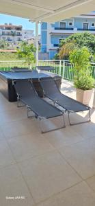 a ping pong table sitting on a patio at Cozy White House - Near Beach Private Jacuzzi in Ksamil