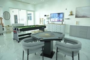 a game room with a pool table and chairs at Al Miqyal Resort - استراحة المقيال - الساد in Al Ain +4 photos