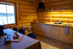 a kitchen with a table and a sink in a room at Silmaļi Tērvetē in Tērvete
