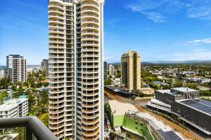a view of a city with a tall building at Stunning City View Beachfront Apartment in Gold Coast