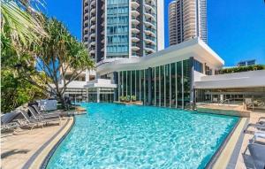 a large swimming pool in front of a building at Stunning City View Beachfront Apartment in Gold Coast