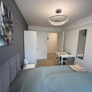 a bedroom with a bed and a table and a desk at Theo in Poznań