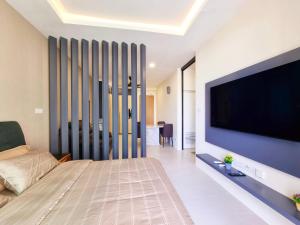 a living room with a large flat screen tv at Blue Cove Riverine Diamond Kuching in Kuching