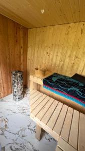 a wooden room with a bed and a bench at Apartment Kristian in Selnica ob Dravi