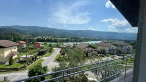 a view from a balcony of a town with a river and mountains at Apartment Kristian in Selnica ob Dravi