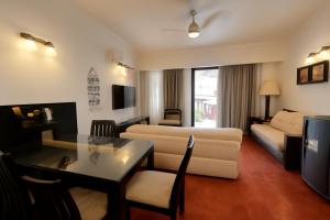 a living room with a couch and a table in a room at Riviera Hermitage in Arpora
