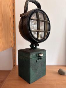 a lamp on top of a green box on a table at Alte Fischerhütte Darss in Wieck