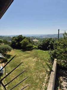 a view of a yard with grass and trees at Casa Maya Langhe e Roero in Pocapaglia