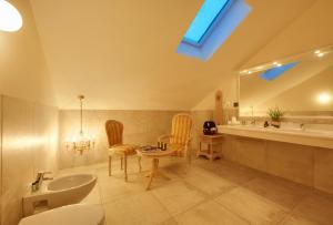 a bathroom with two chairs and a sink at Historic Hotel Bircher B&B Apartments near Sterzing in Campo di Trens +116 photos