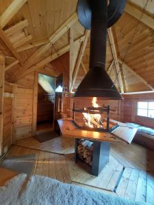 a large fireplace in a wooden room in a cabin at VILA v ZAHRADÁCH in Uherské Hradiště