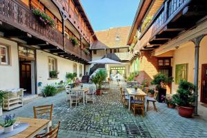 an outdoor patio with tables and chairs in a building at Altes Kontor in Bad Sulza