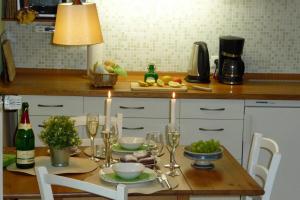 a table with glasses of wine and food on it at Altes Kontor in Bad Sulza
