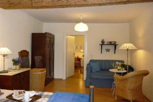 a living room with a blue couch and a table at Altes Kontor in Bad Sulza