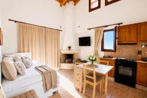 a bedroom with a bed and a kitchen with a table at 5 Stars Villas in Svoronata