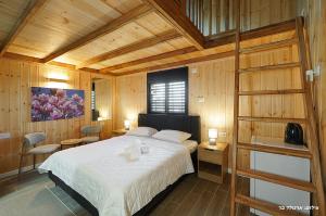 a bedroom with a large bed and wooden walls at Novus Luxury in Yarka +83 photos