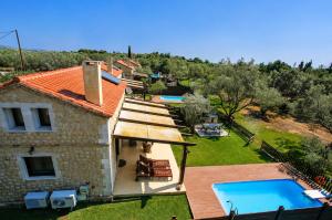 an external view of a house with a swimming pool at 5 Stars Villas in Svoronata
