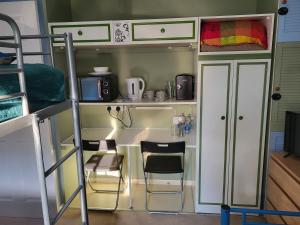 a room with a desk and chairs in a bunk bed at Mudeford Swans in Christchurch