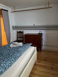 a bedroom with a bed and a dresser in it at Storgatan 42 in Högsby +5 photos